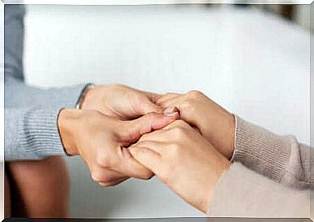 Four hands that touch each other in an empathetic way. 