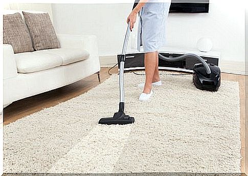 woman vacuuming a carpet