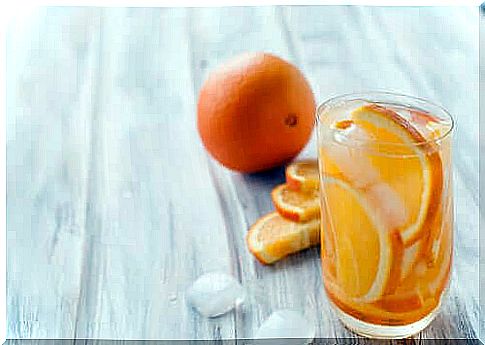 A glass of water and orange.