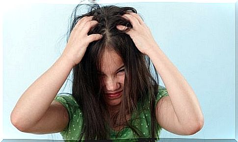 child scratching his hair 