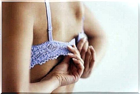 A woman undoes her bra