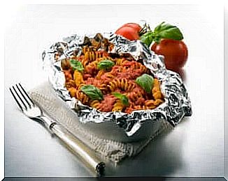 A pasta salad in aluminum foil. 